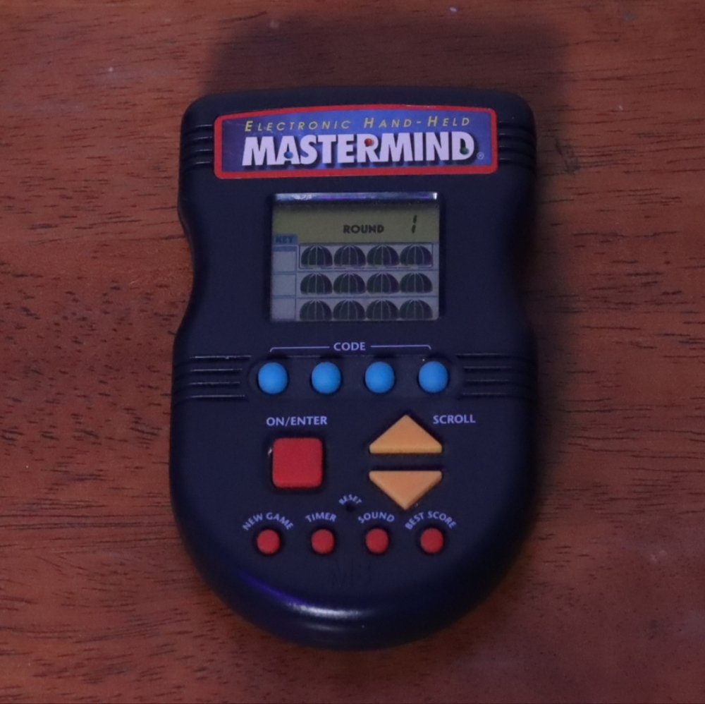 Hasbro Mastermind Handheld Electronic Game - Black with Blue and Yellow Buttons